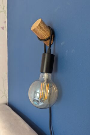 Wooden Wall light fixture attached to a wall with optional Smart Bulb