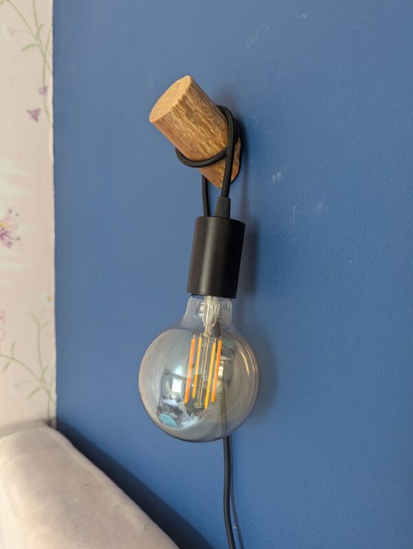 Wooden Wall light fixture attached to a wall with optional Smart Bulb